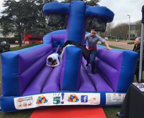 school team building activity bungee run with players running along the inflatable with a bungee cord attached to them