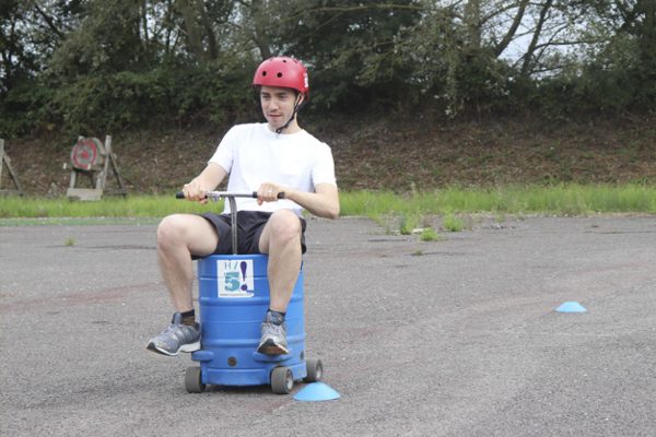 motorised beer kegs racing around the course also completing a pit stop challenge before tagging a team member